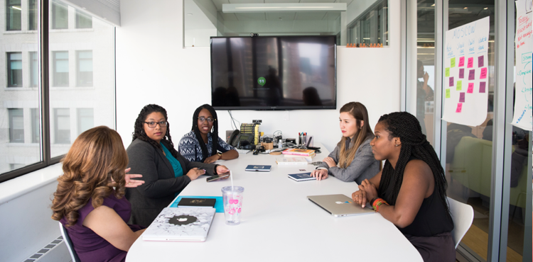 Five woman sitting in a meeting